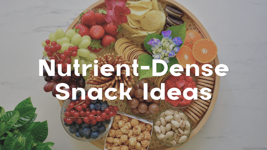 Round snack tray filled with fruit, nuts, olives, crackers, pretzels, popcorn, and other snack foods, with the text “Nutrient-Dense Snack Ideas” displayed prominently across the image.