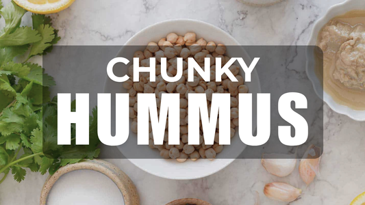 Tal's Mediterranean Chunky Hummus banner featuring chickpeas, fresh cilantro, lemon, garlic, and creamy hummus, highlighting authentic Mediterranean ingredients and bold homemade flavor.