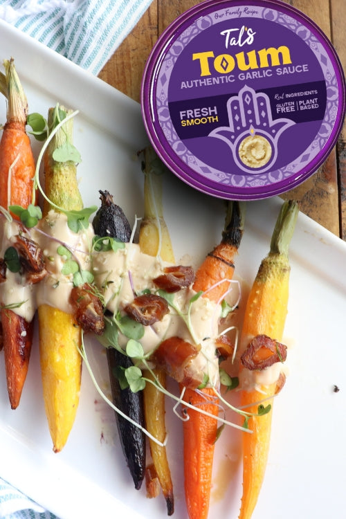 Side dishes on a plate featuring Tal's Toum Authentic Garlic Sauce Fresh Smooth at the forefront.
