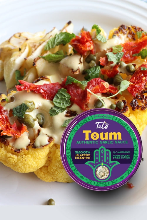 Spicy Cauli Steak on a plate featuring Tal's Toum Authentic Garlic Sauce with Smooth Jalapeno Cilantro flavor.