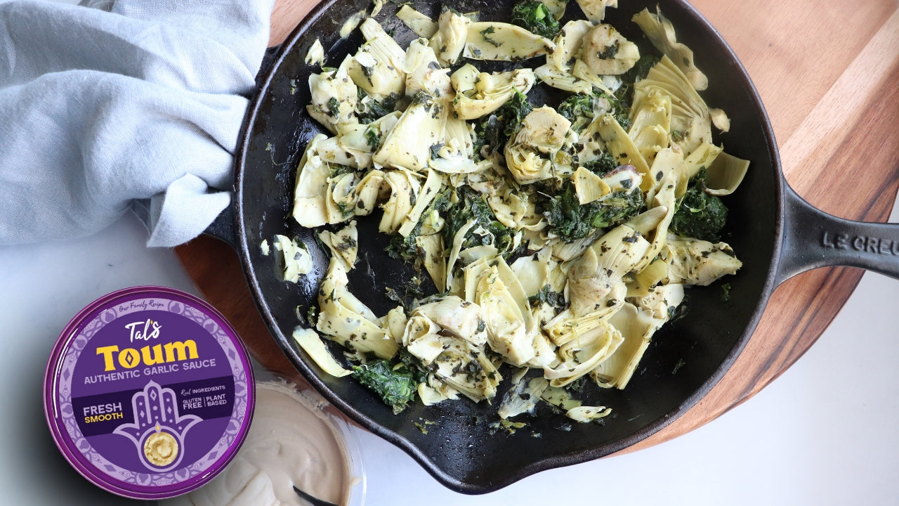 Spinach Artichoke Salad on a plate with Tal's Toum Authentic Garlic Sauce Fresh Smooth featured
