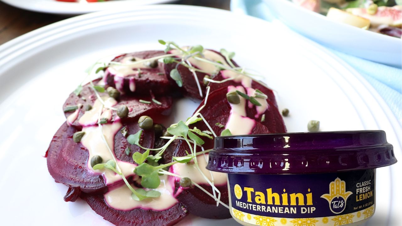 Earthy roasted beets on a plate with Tal's Mediterranean Tahini Mediterranean Dip in Classic Fresh Lemon flavor