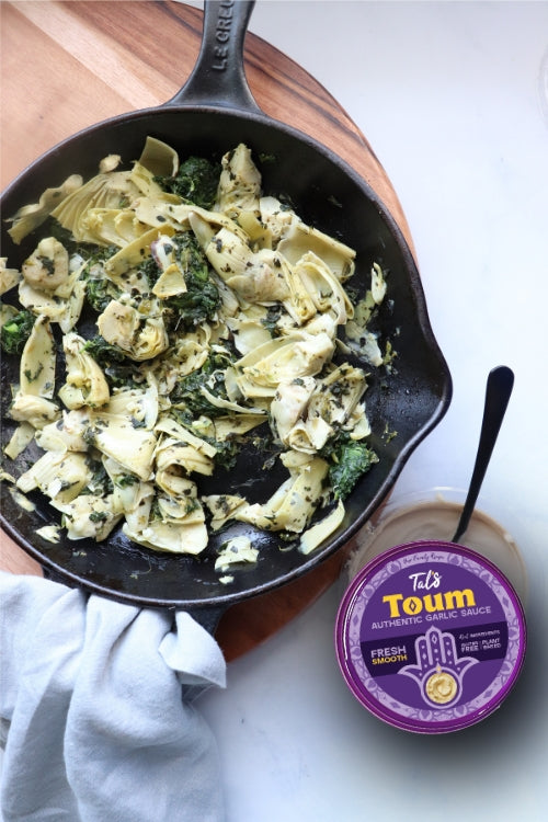 Spinach Artichoke Spread on a plate paired with Tal's Mediterranean Toum Authentic Garlic Sauce for a smooth, garlicky flavor