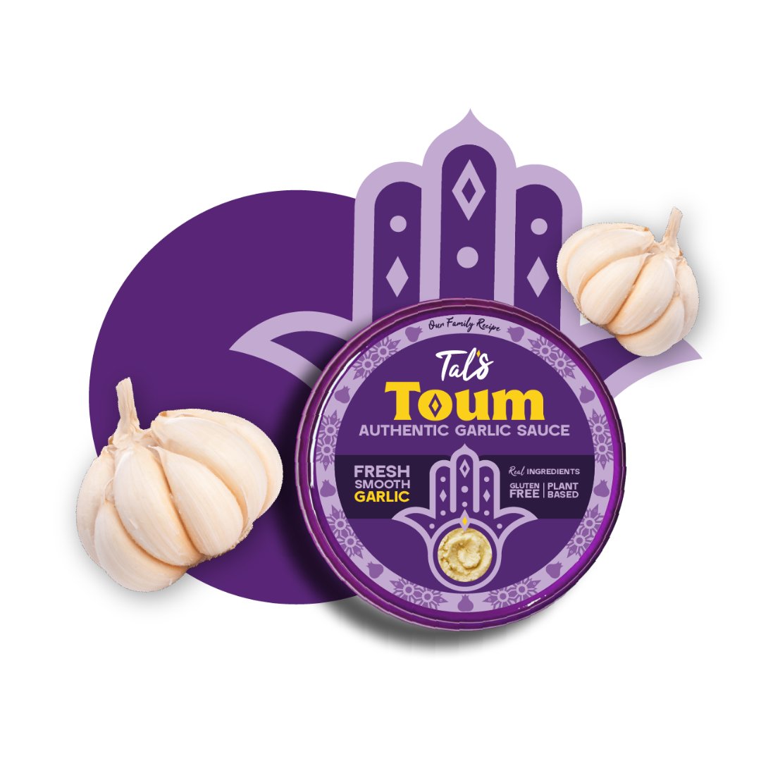 Tal's Toum Authentic Garlic Sauce product packaging displayed on a light background with a purple Mediterranean-inspired design. A round purple tub labeled “Tal's Toum Authentic Garlic Sauce” is centered over a stylized purple graphic motif, with whole garlic bulbs positioned on the left and upper right sides. The packaging highlights fresh smooth garlic, gluten-free, and plant-based attributes.